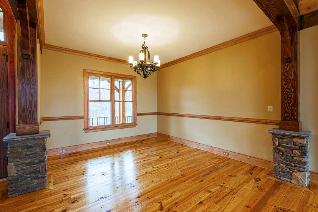 A wide plank hardwood flooring shows the natural knots of original antique heart pine wood.