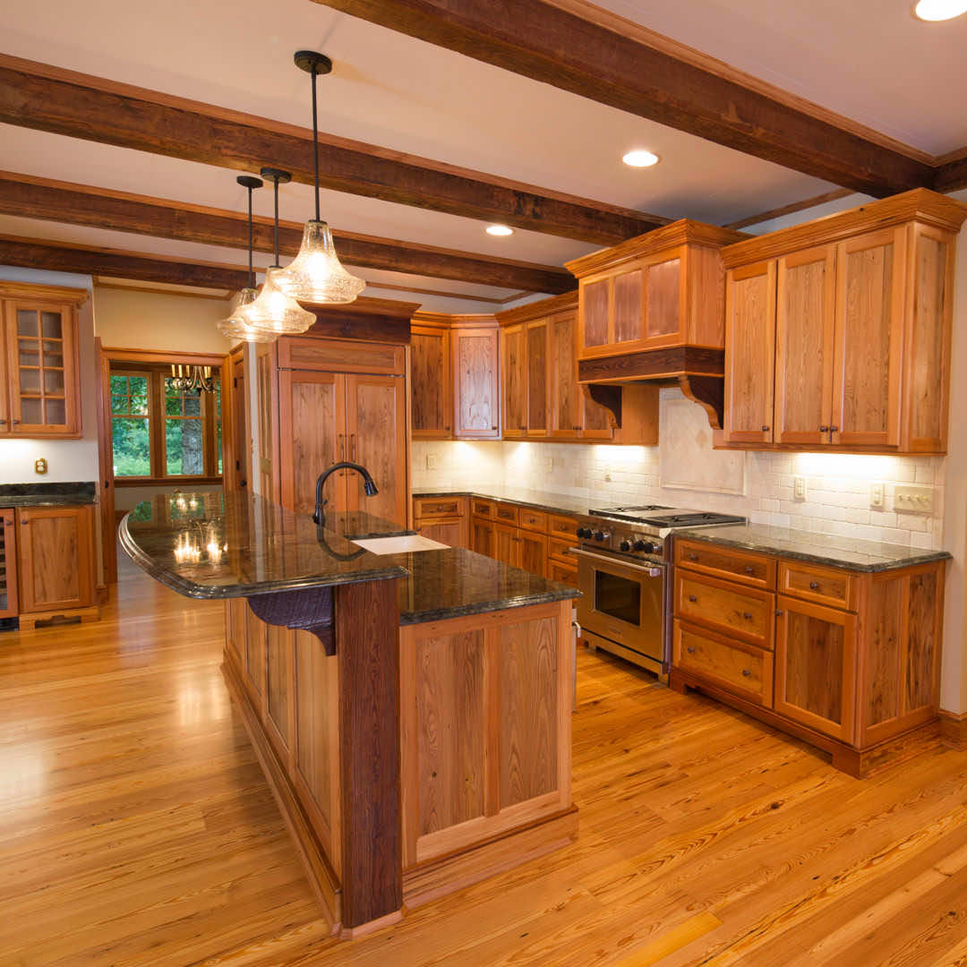 A newly renovated kitchen with reclaimed wood flooring, which is the best wood floor for a kitchen.