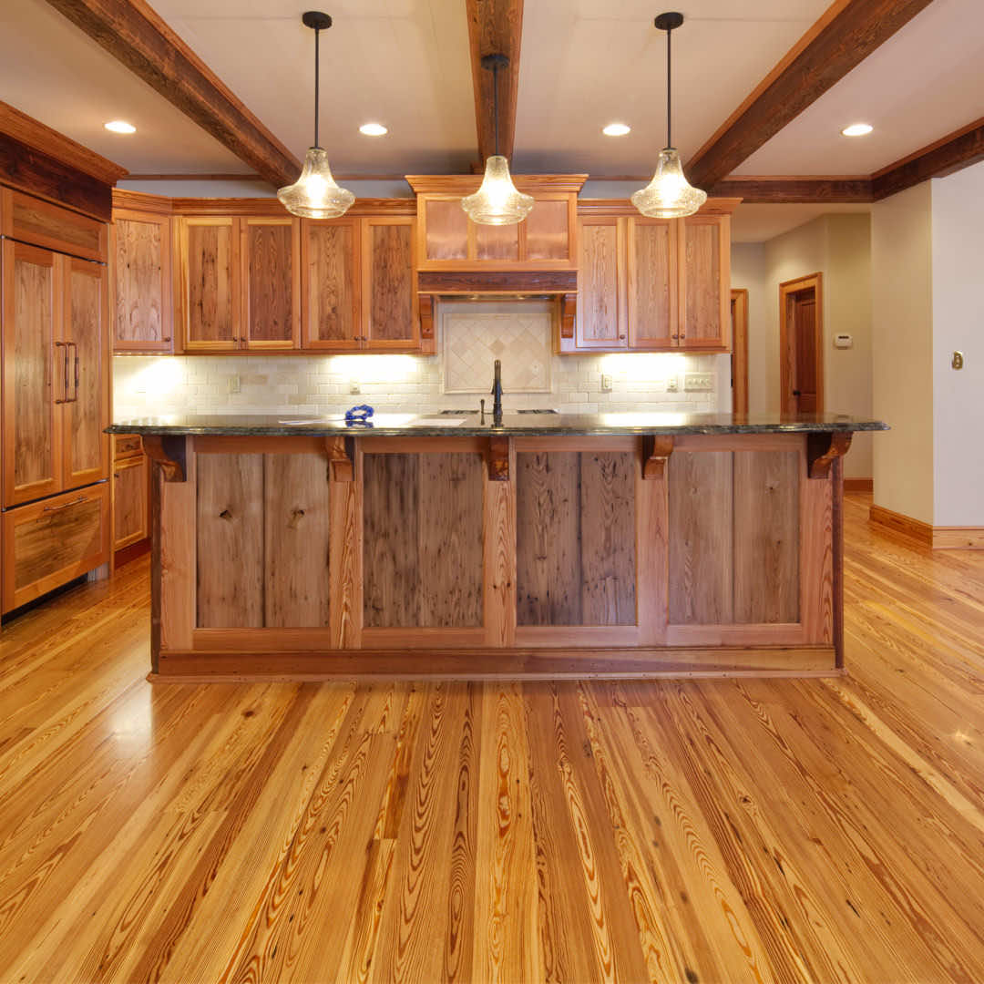 Mixed wood flooring laid in a random width pattern brings a simple, rustic feel to a kitchen.